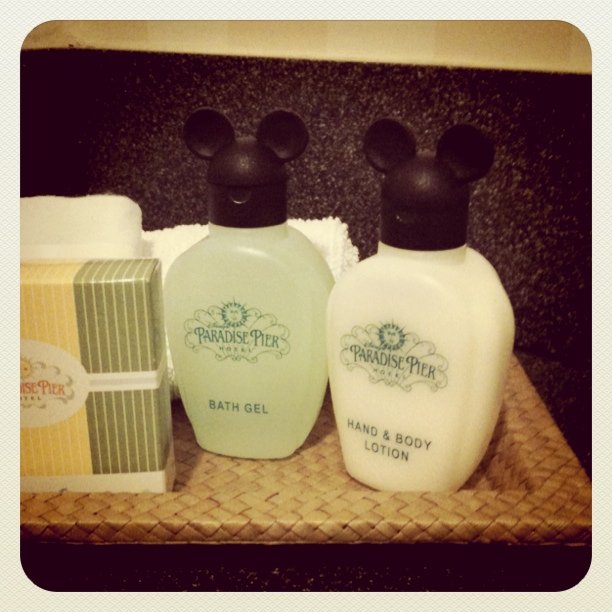 two small Paradise Pier Hotel bottles of bath gel and lotion each with plastic mickey ear lids