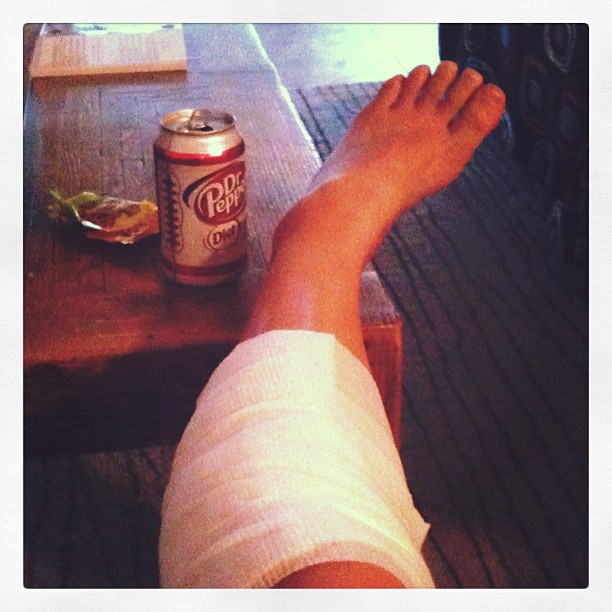 leg wrapped in a bandage next to a Diet Dr. Pepper