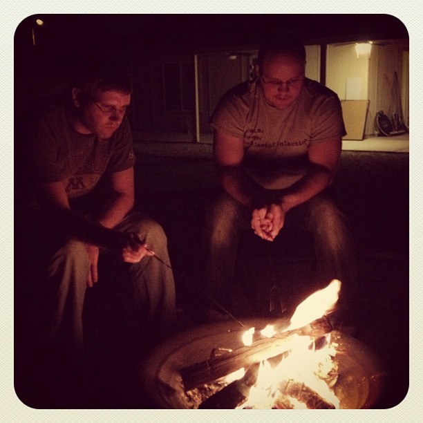 Clay and Jake sitting by a fire pit