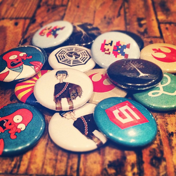 1-inch buttons of various emblems from Futurama, Star Wars, Lost, and Super Mario