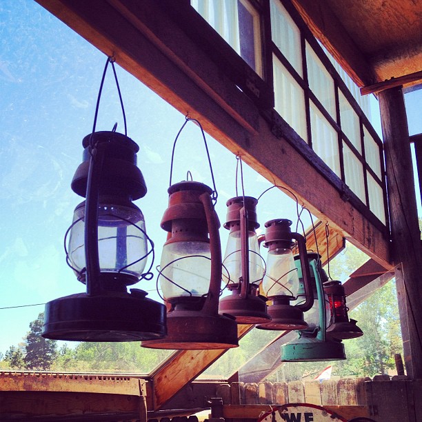 row of vintage lanterns hanging from a beam