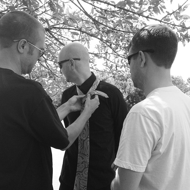 Austin helps Nate tie his tie while Clay supervises