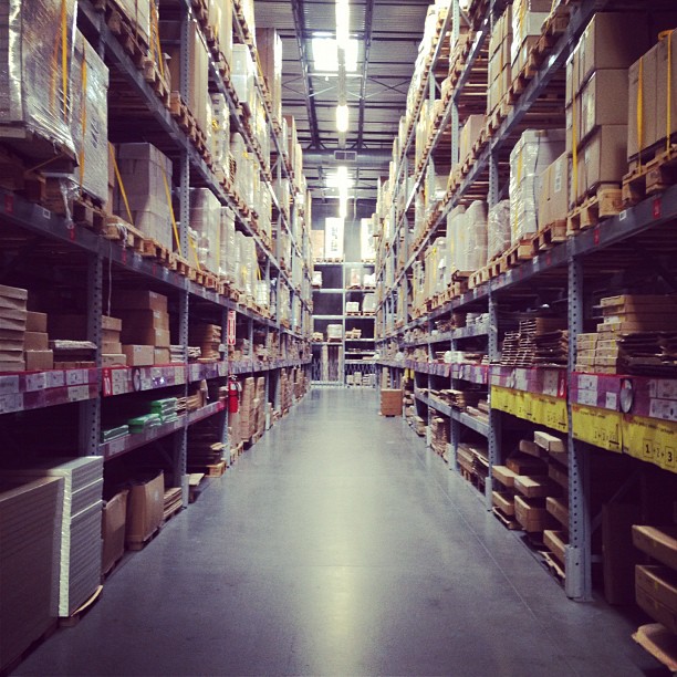 warehouse shelves filled with cardboard packages