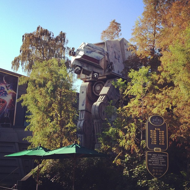 entrance to Star Tours at Disney World featuring a giant AT-AT coming out of the trees