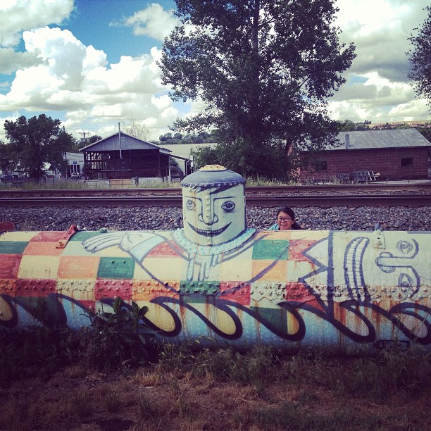 Lynn popping her head up from behind a big tank painted like a guy