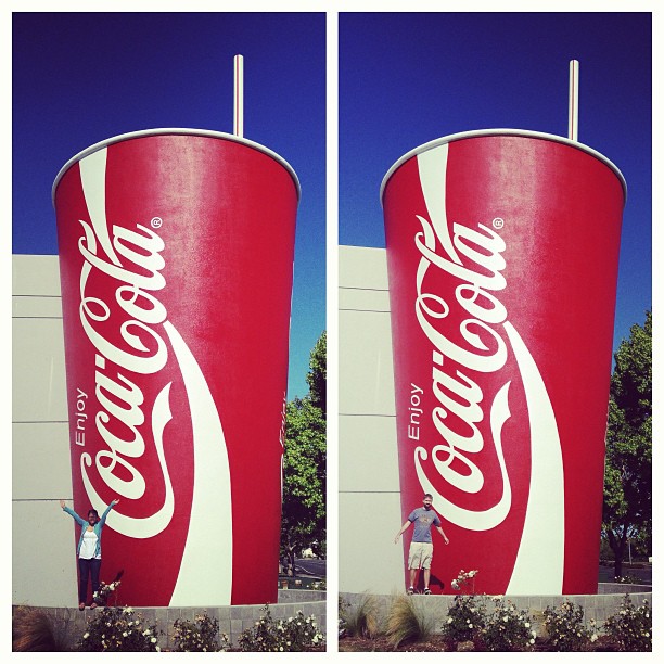 Lynn and Clay posing in front of a huge Coke cup with straw