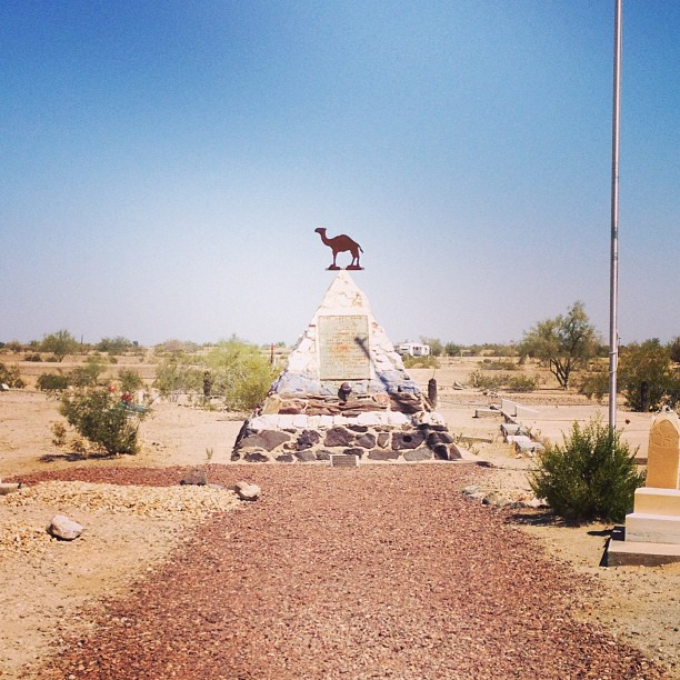 monument shaped like a pyramid with a camel on top