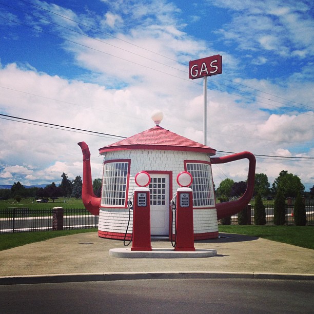 a gas station shaped like a tea pot with red spout and handle