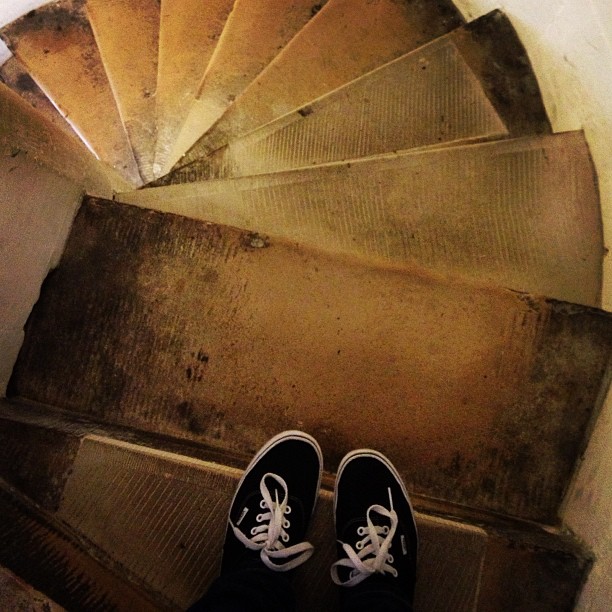 a pair of Vans on a winding stone staircase