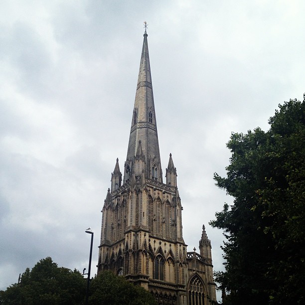 gothic church steeple against a cloudy sky