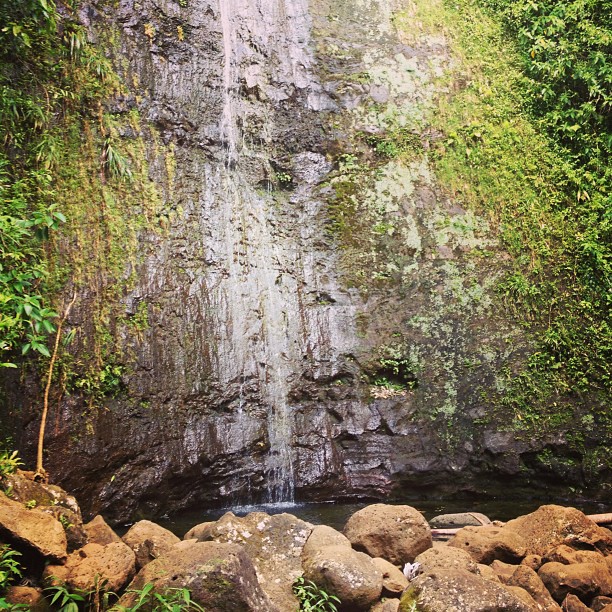 small waterfall along a large rock face