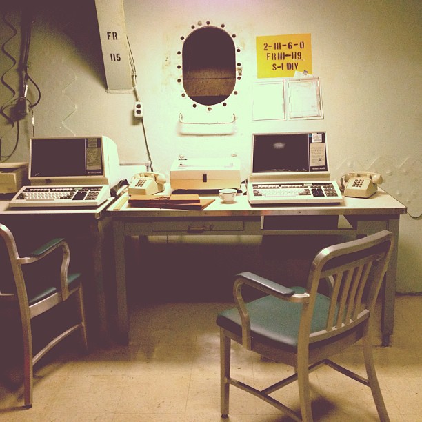 ship workspace with mid-century styling, furniture, and tech as if preserved in time