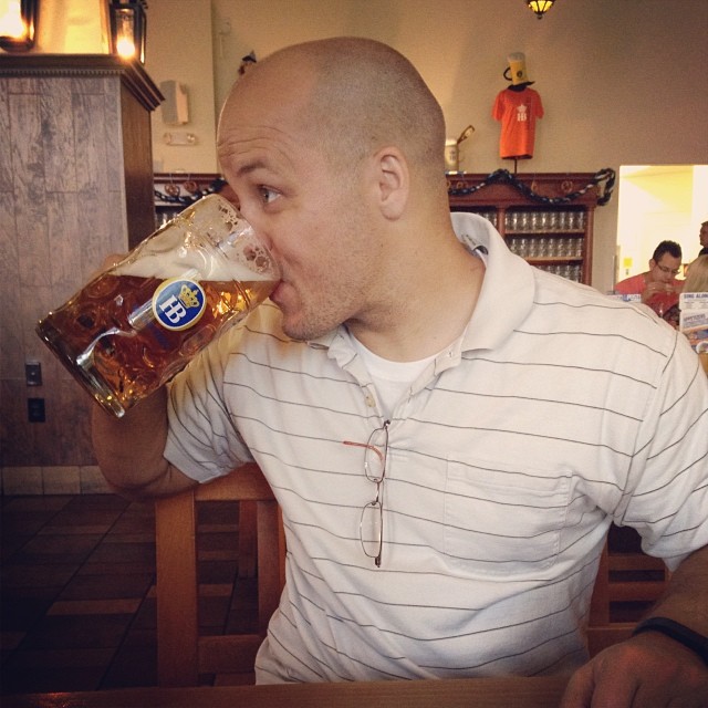 Jake taking a big drink of beer from a huge glass mug