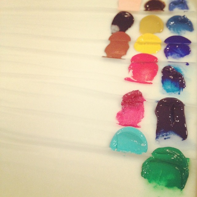 splotches of differently colored paint on a palette