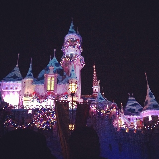 Sleeping Beauty castle at Disneyland lit up at night