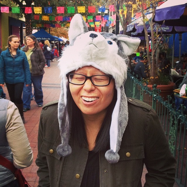 Lynn making a squinty face while wearing a wolf hat