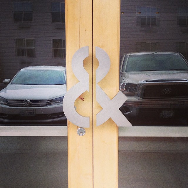 two office doors with an ampersand as the door handles