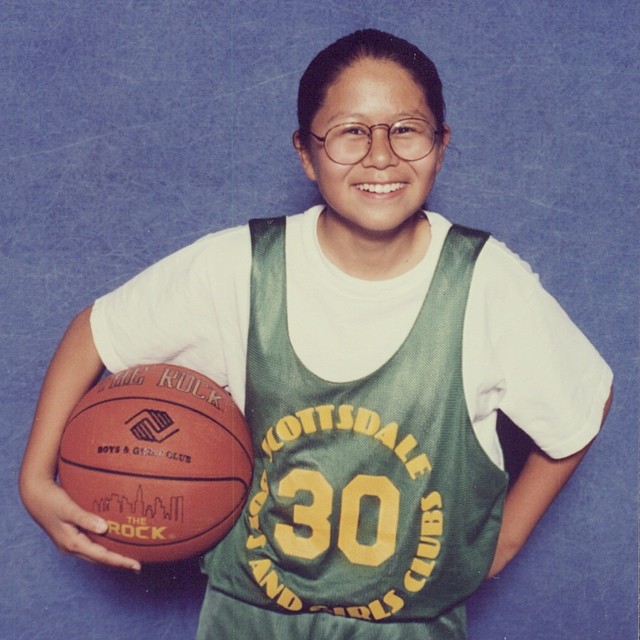 10-year-old Lynn in her basketball photo with round glasses and oversized jersey