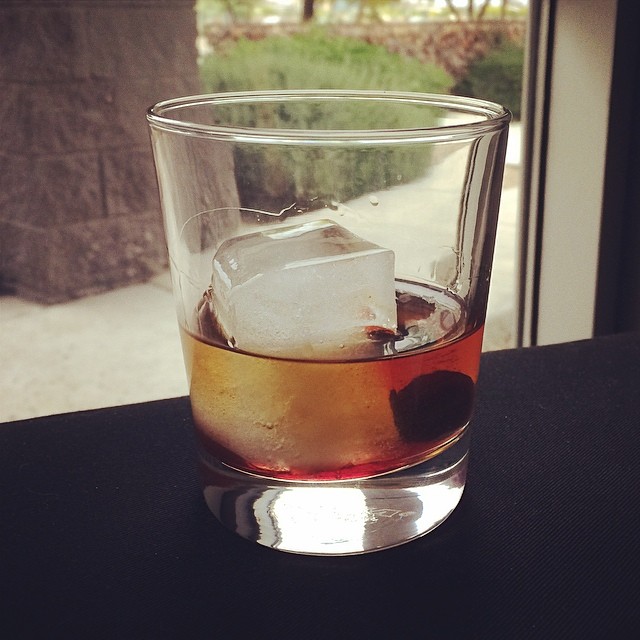 glass of bourbon with a nice big ice cube