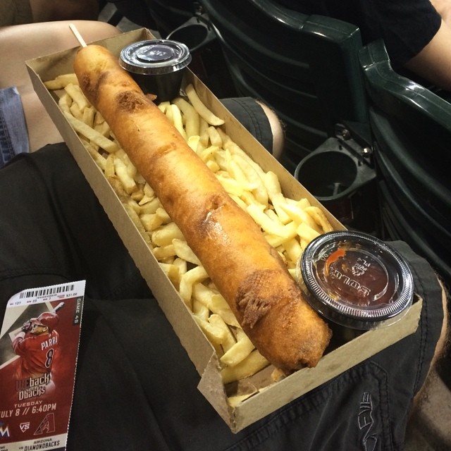 huge corn dog on a giant bed of fries