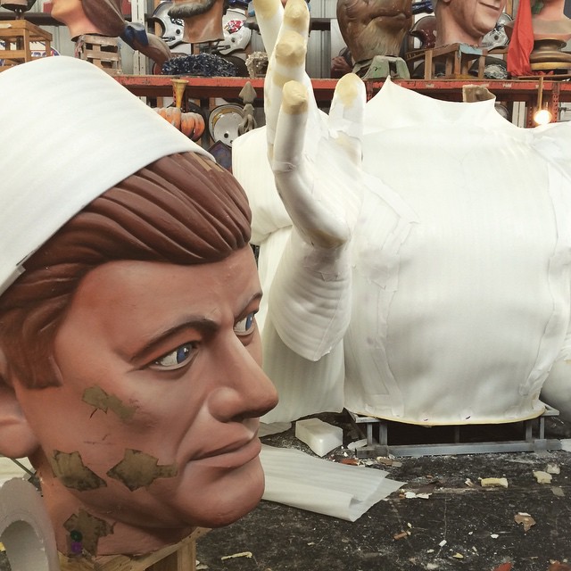 huge partially painted sculptures of a man’s head and separate torso