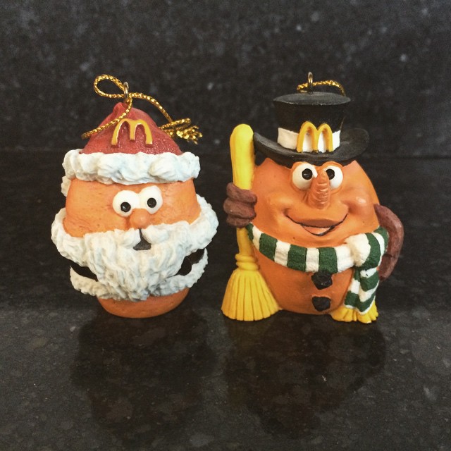 two chicken Mcnugget ornaments with faces, one dressed as Santa and the other dressed as Frosty