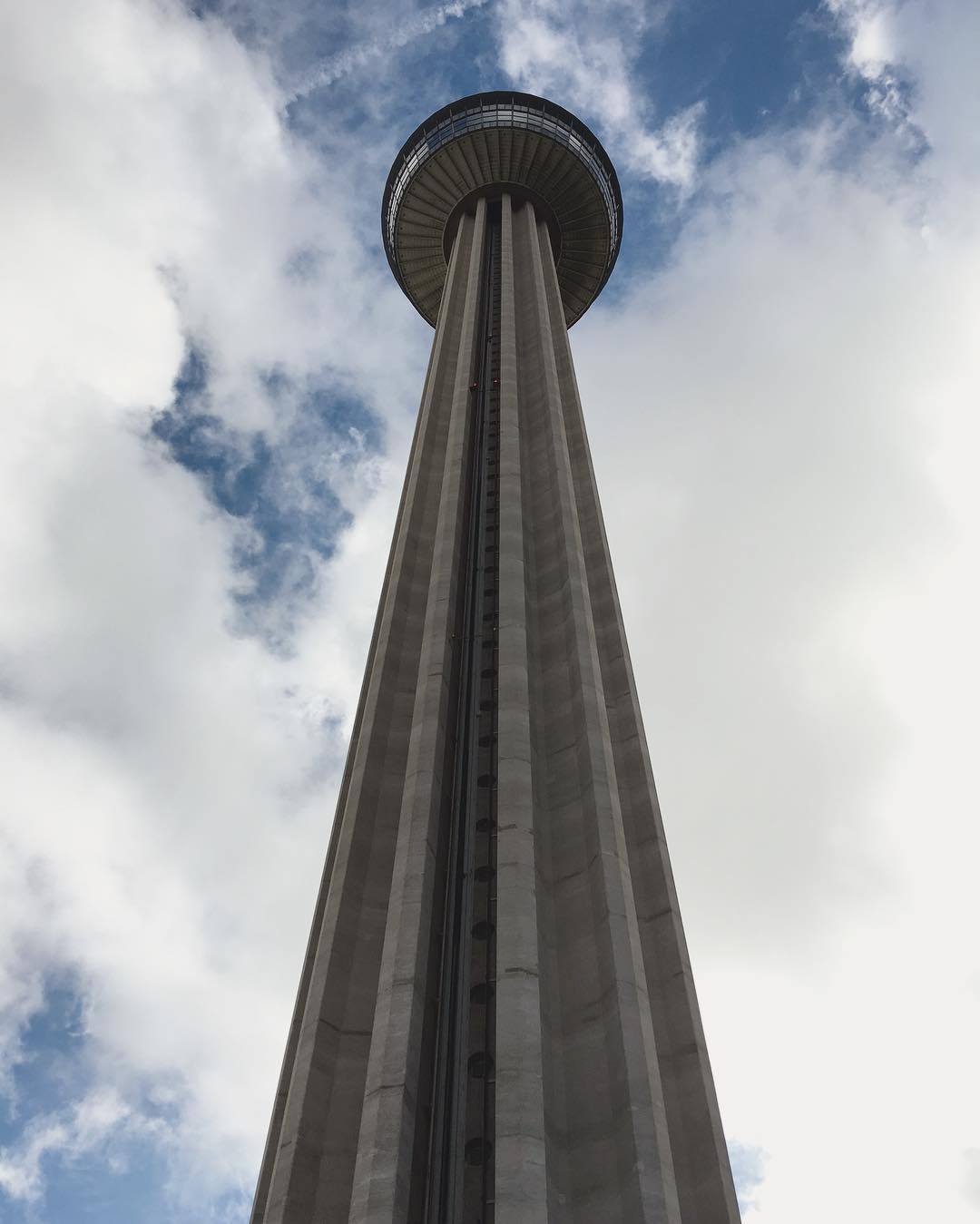 clouds surround the Tower of the Americas from way below