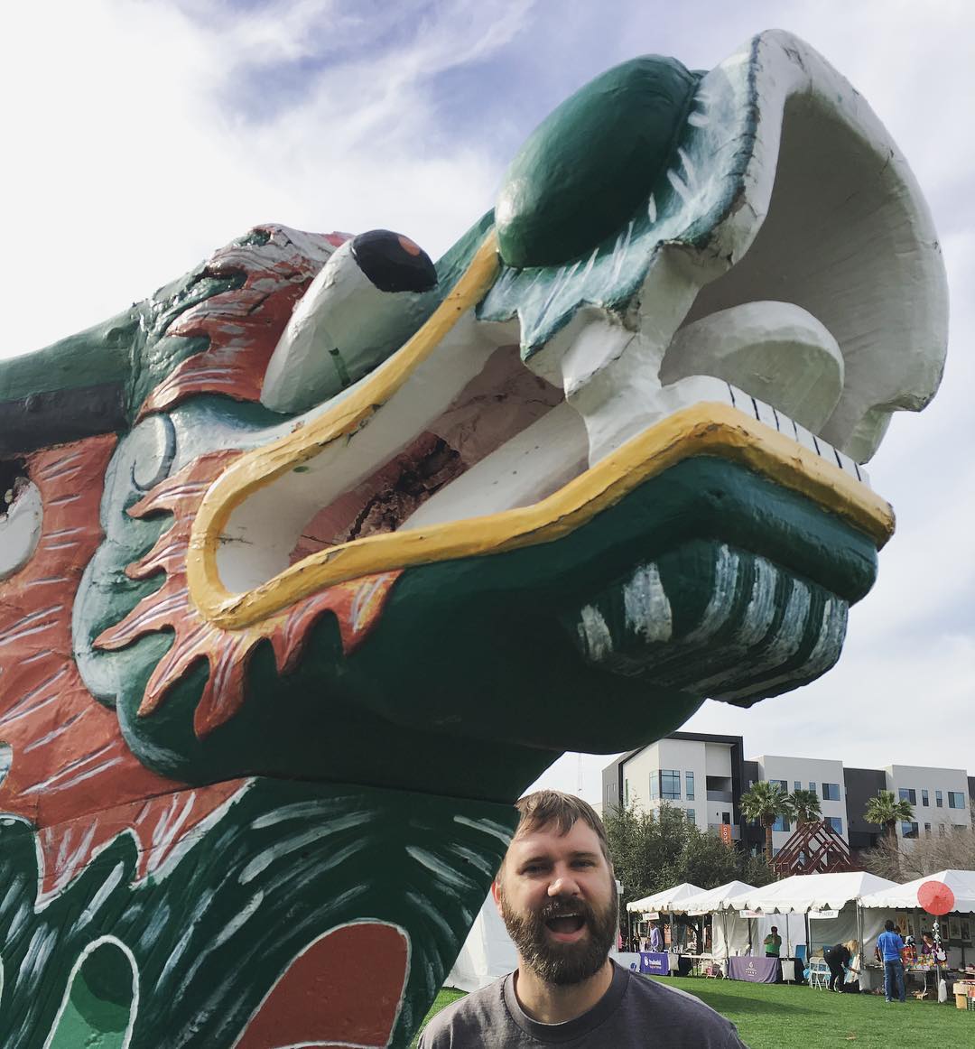 Clay excited to be near a giant dragon statue