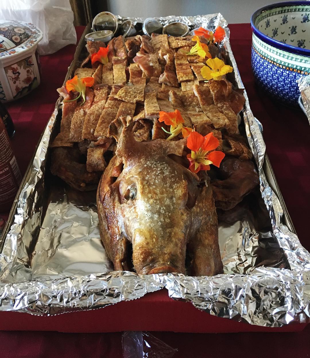 whole roast pig sliced up with head still attached