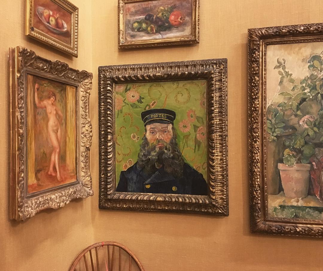 corner of paintings including Van Gogh’s The Postman