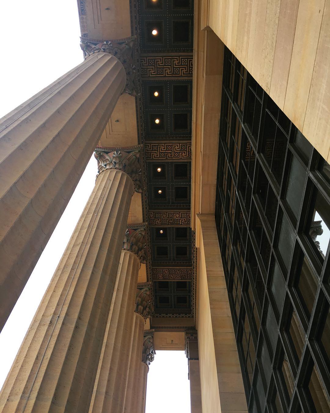 looking up at the tall columns and ceiling of the museum’s entrance