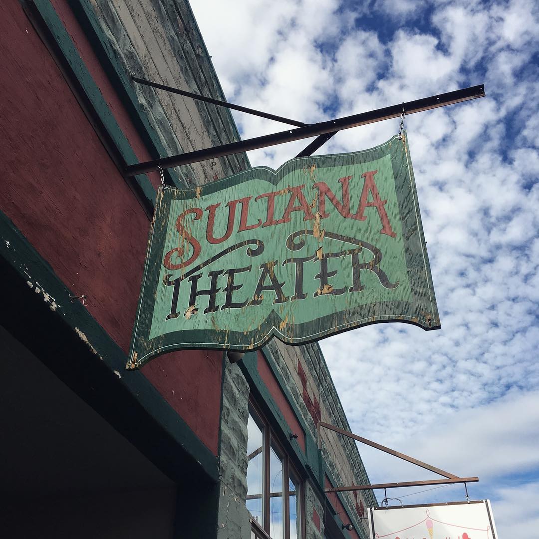 old Sultana Theater wood sign shaped like a book