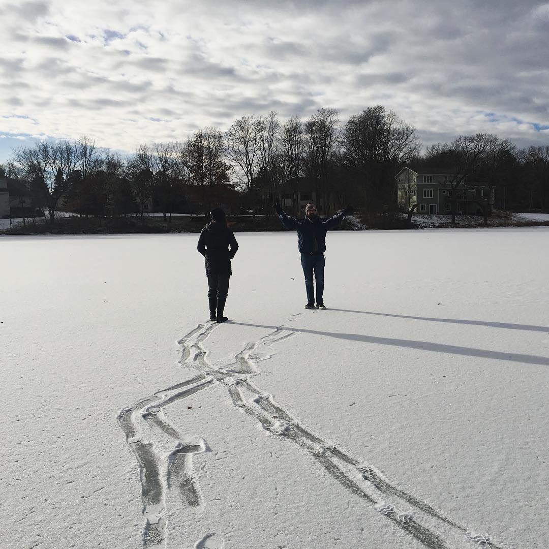 two people making tracks on freshly fallen snow