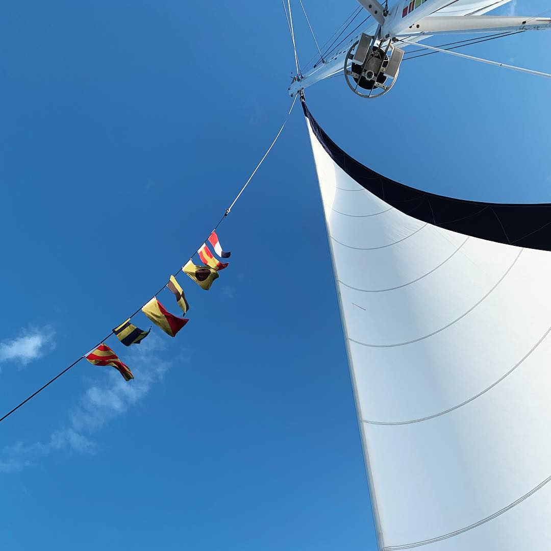 blue and white sail against the blue sky