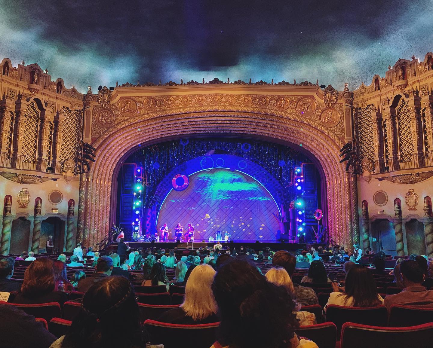 inside the Orpheum: a stage flanked by architectural details and a starry ceiling; on the stage is the setup for the Sponge Bob musical